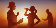 Trois jeunes boivent de la bière en fumant des cigarettes ou des drogues.